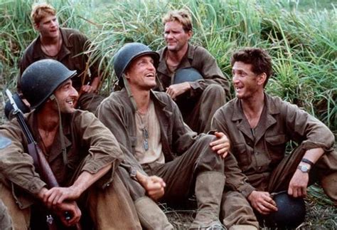 A group of soldiers talk and laugh.